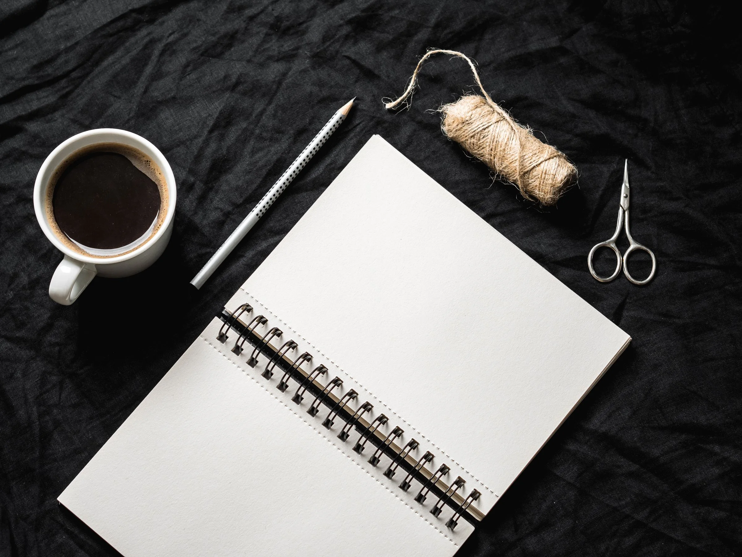A carefully arranged desk with objects, notes, tools, and materials for the MethodCo system