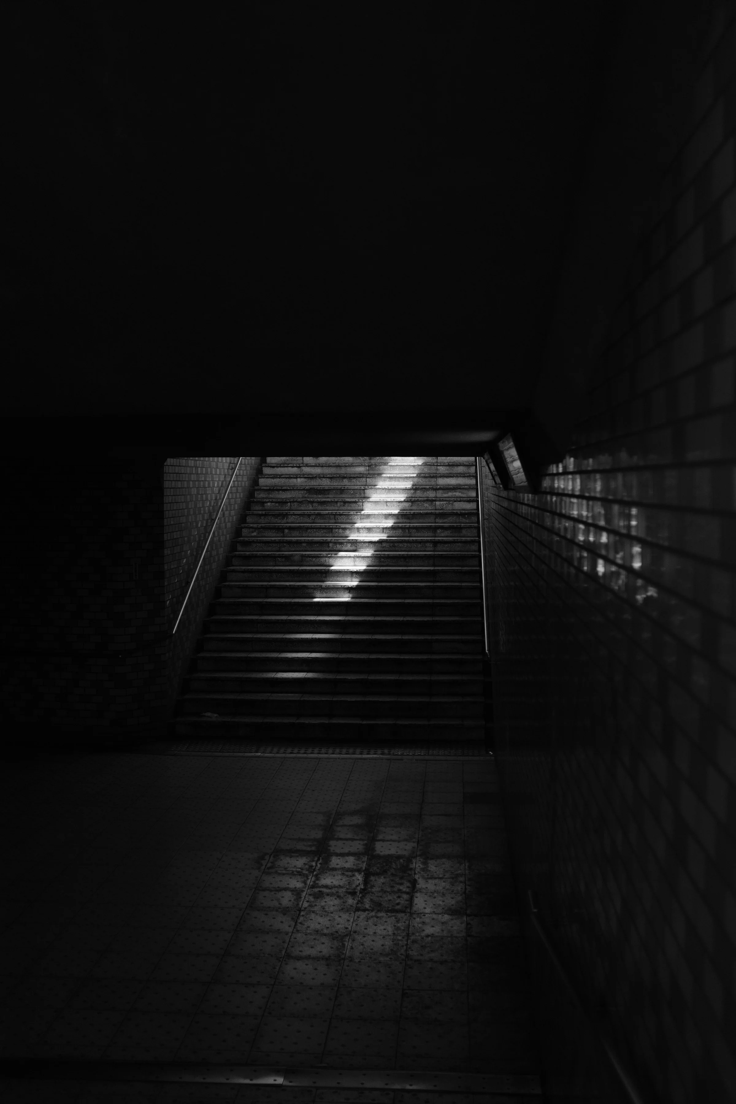 Dark steps lit from above as a calm starting path